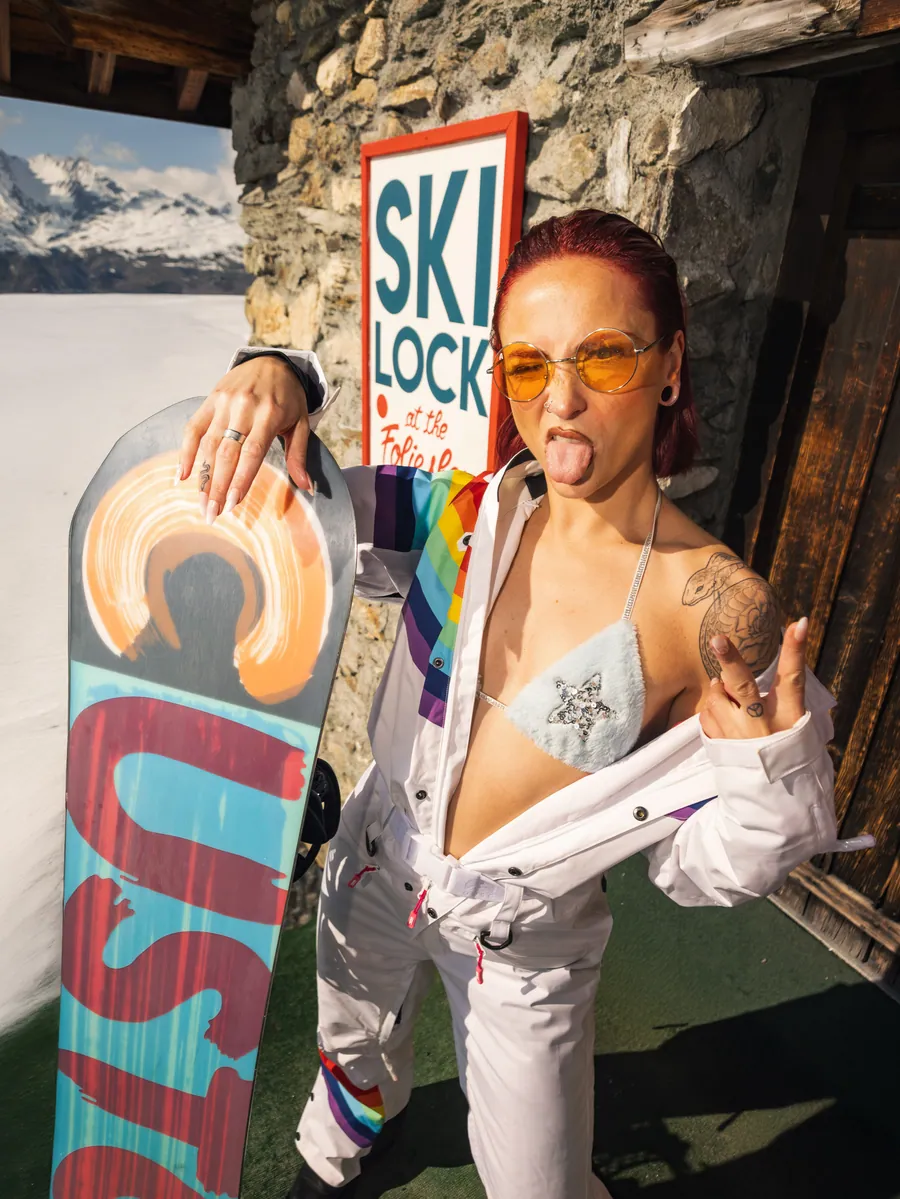 Portrait en combinaison blanche avec un snowboard