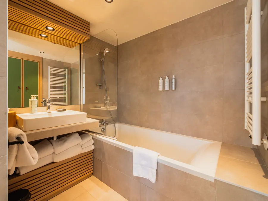 Salle de bain avec baignoire et meuble en bois