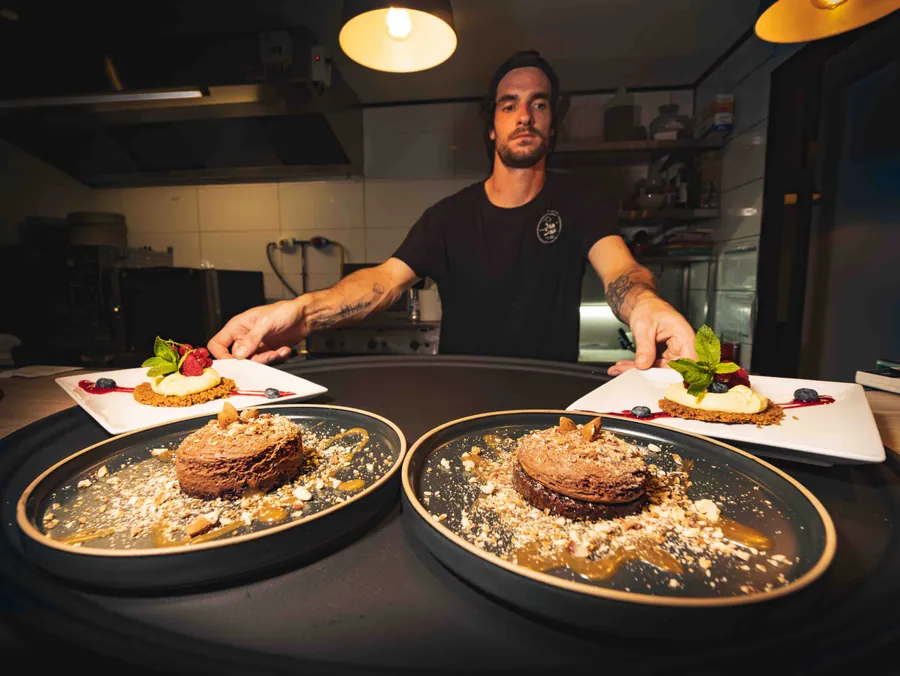 Le chef au passe avec les plats prêts au service à Otra Cosa, Soustons plage